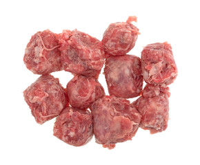 Top view of several slices of raw mild bratwurst sausage isolated on a white background.