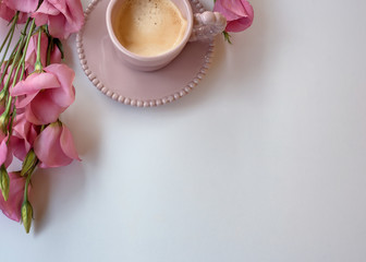 Coffee background in a beautiful pink cup and pink Lisianthus.