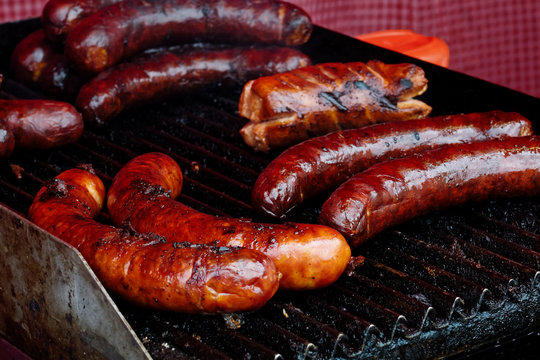 Bratwurst sausages on cast iron griddle.