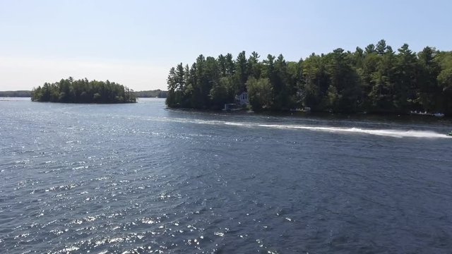 aerial seadoo skipping across water in cottage country low dynamic flight 4k