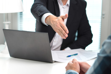 Business man offer and give hand for handshake in office. Successful job interview. Apply for loan in bank. Salesman, bank worker or lawyer shake for deal, agreement or sale. Increase of salary.