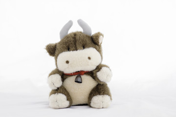 stuffed animal cow on a white background .