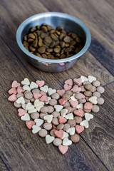 dry dog food in bowl and vitamins for healthy  dog treats 