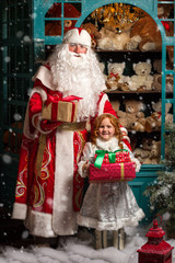 Father Frost and Snow Maiden standing with gifts