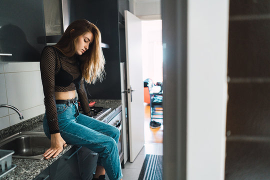 Sensual trendy girl posing on kitchen
