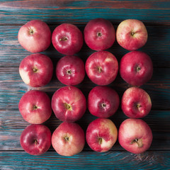 Red apples over rustic wooden background