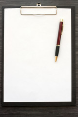 Black  clipboard with blank sheet of paper and metal pen isolated on white background. Top view