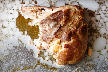 Cold roast pork surrounded by congealed fat from above.