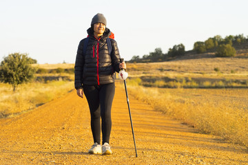 Camino de Santiago pilgrim woman  walking  to Compostela near Astorga  , Leon , Spain