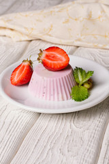 Panna cotta with blueberries jam and strawberries