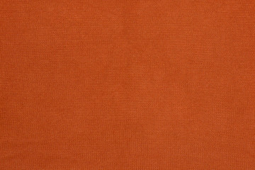 Orange texture of a sweater. Fabric with the texture of a knitted sweater.