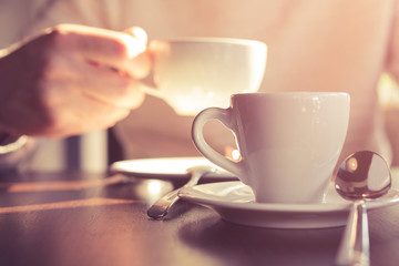 Man drinking coffee at cafe.