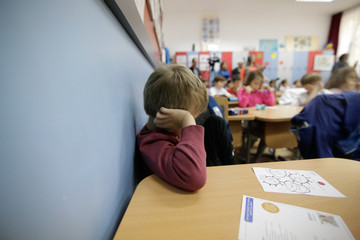 Sad pupil in classroom