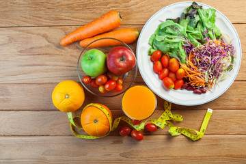 Healthy concept with mixed fruits and vegetables on wooden background