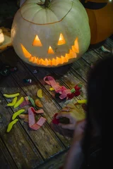 Foto op Plexiglas Children pick up candy along with the pumpkin, halloween © karrastock