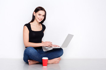 Freelancer woman with laptop and coffee at home