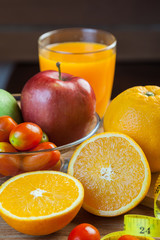 Healthy concept with mixed fruits and vegetables on wooden background
