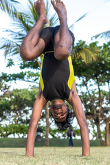 Obraz premium Young yoga man practitioners doing yoga on nature. Asian indian yogis man on the grass in the park. Bali island.