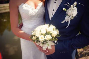 Bride holding a bouquet of white roses luxury