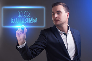 The concept of business, technology, the Internet and the network. Young businessman showing inscription: Link building