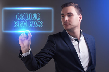 The concept of business, technology, the Internet and the network. Young businessman showing inscription: Online reviews