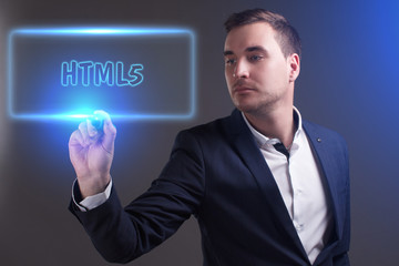 The concept of business, technology, the Internet and the network. Young businessman showing inscription: HTML5