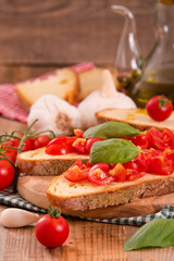 Bruschetta bread with basil and chopped tomatoes. 