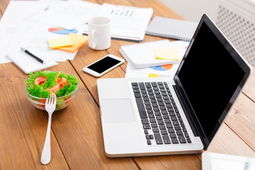 Business background. Healthy lunch and laptop in modern office
