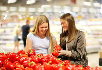  Girls buying vegetables at the market