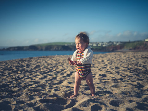 Baby with sunglasses on the beach