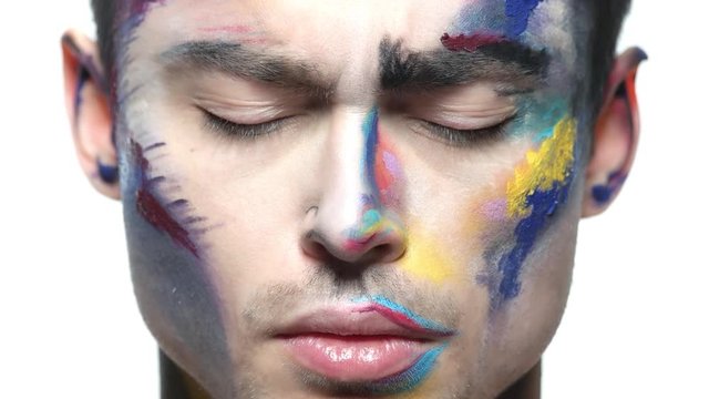 Face paint makeup, young man. Sad caucasian guy.