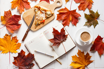 Autumn breakfast with coffee, pizza and diary. Top view concept