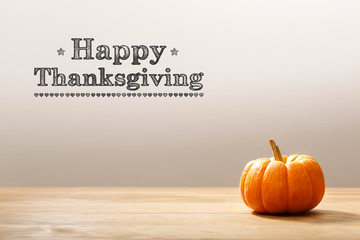 Thanksgiving message with a orange small pumpkin