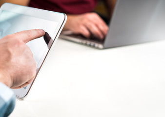 Business people working together in modern office and having meeting. Negative empty blank copy space for content. Sharing ideas, teamwork and start up concept. Using tablet and laptop.