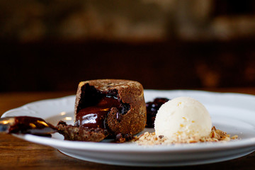 chocolate Fondan with syrup and ice-cream on a plate