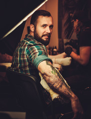 Man at tattoo artist session