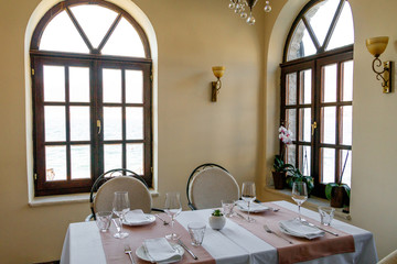 Interior of a Mediterranean restaurant Beautiful windows table setting