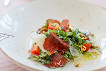 Green salad with Parma ham and Tomato. Sprinkle with parmesan cheese. Healthy food style - Processing Warm White balance. Healthy vegetables salad.
