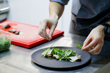 Chef makes beetroot salad with organic parsley.