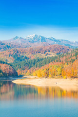 Panoramic view of Lokvarsko lake with Risnjak mountain in background, beautiful colorful mountain autumn landscape, Lokve, Gorski kotar, Croatia 