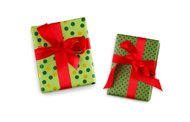 Gift box wrapped in green paper and red ribbon