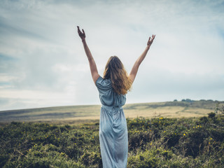 Beautiful young woman in dress on the moor