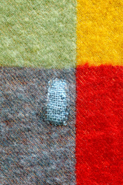 repaired hole in a woolen blanket