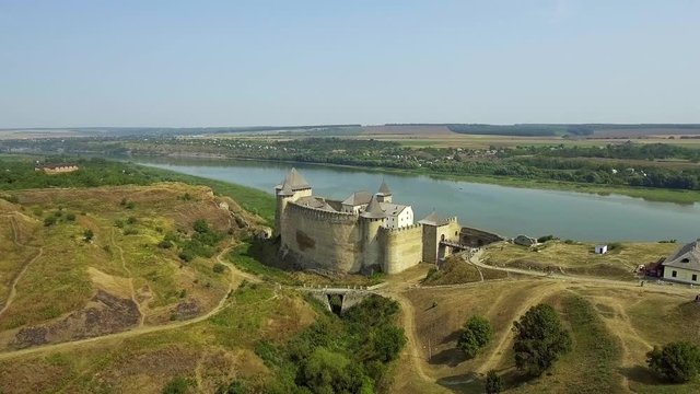Aerial view of Khotyn medieval castle on the green hill above the river.
