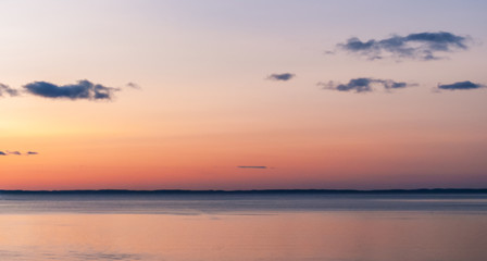 Sunset on the sea. pink sky with clouds