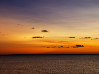 Orange sunrise over the lake in summer