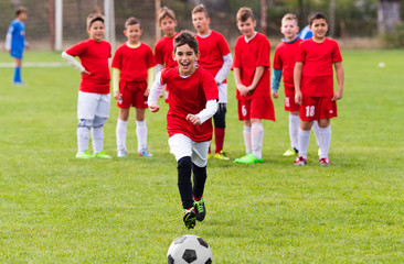 Kids soccer football - children players match on soccer field
