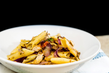 Pasta with pesto sauce and nuts on a the table
