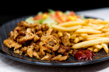 Fresh chicken steak with tomatoes and french fries