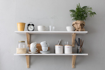 Fototapeta na wymiar Utensils and mugs on shelf